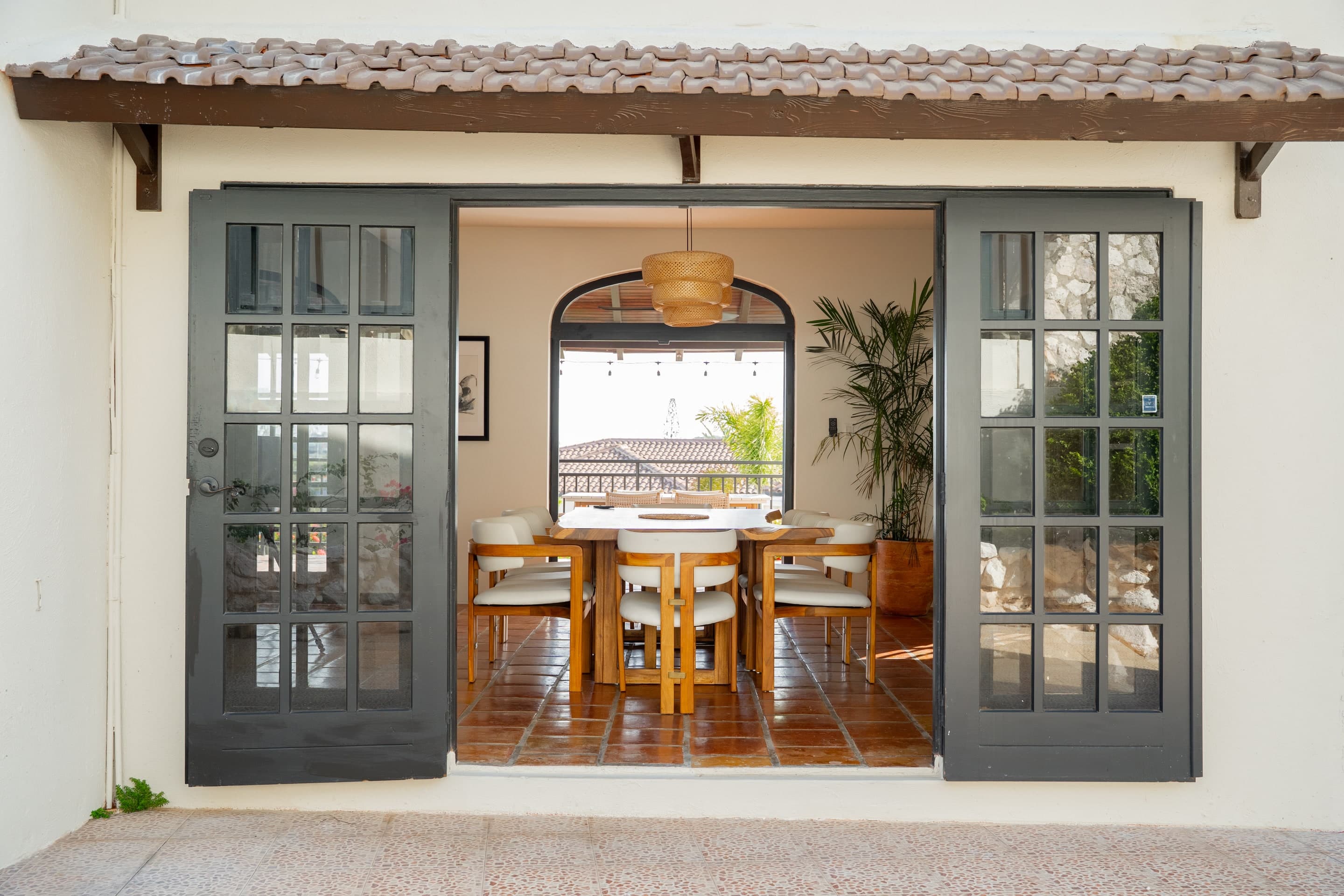 Dining area at The Villa Elizabeth, seen through open charcoal French doors